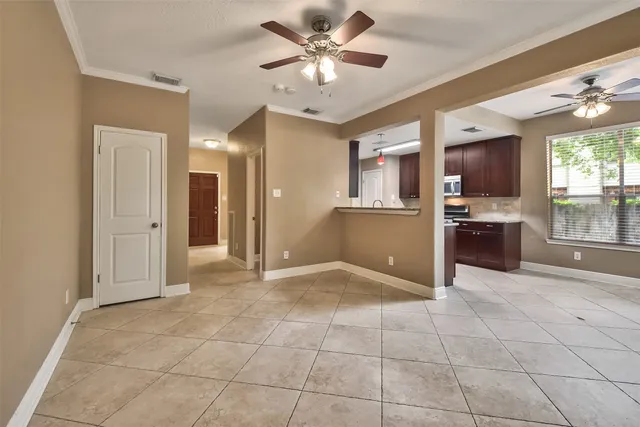 a view of a kitchen with a sink and a refrigerator