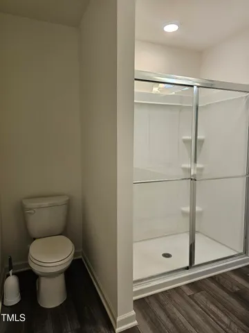 a view of an empty room with a chandelier fan