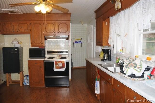 1673 Cat Square Road Vale, NC 28168 - Photo 18 of 24 a kitchen with stainless steel appliances a sink a stove a refrigerator cabinets and wooden floor