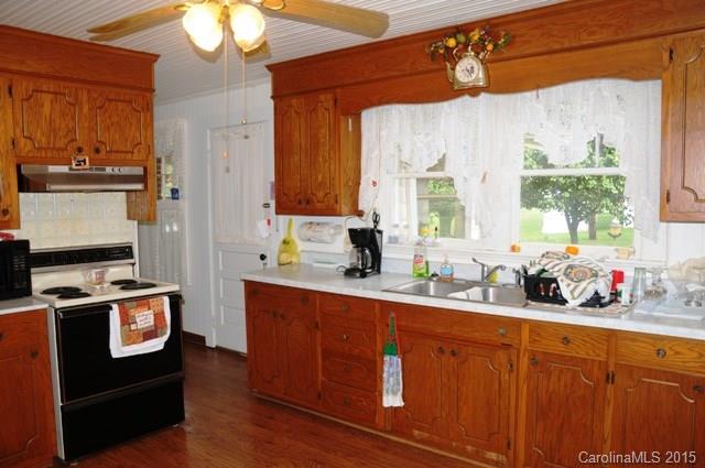 1673 Cat Square Road Vale, NC 28168 - Photo 19 of 24 a kitchen with stainless steel appliances a sink dishwasher stove and wooden cabinets