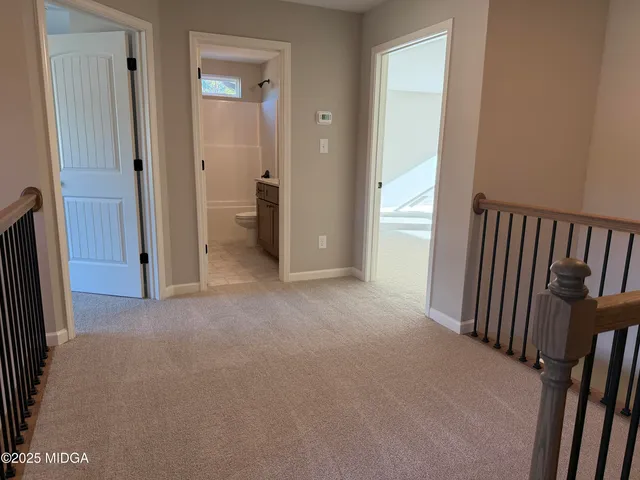 an empty room with closet and a bathroom