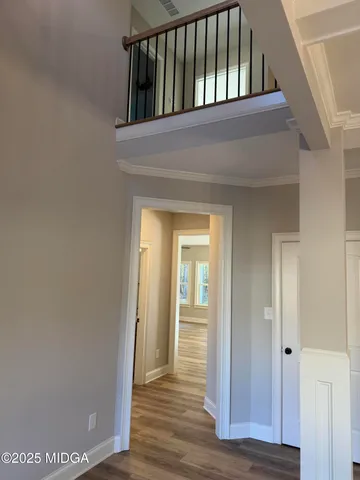 a view of hallway with wooden floor