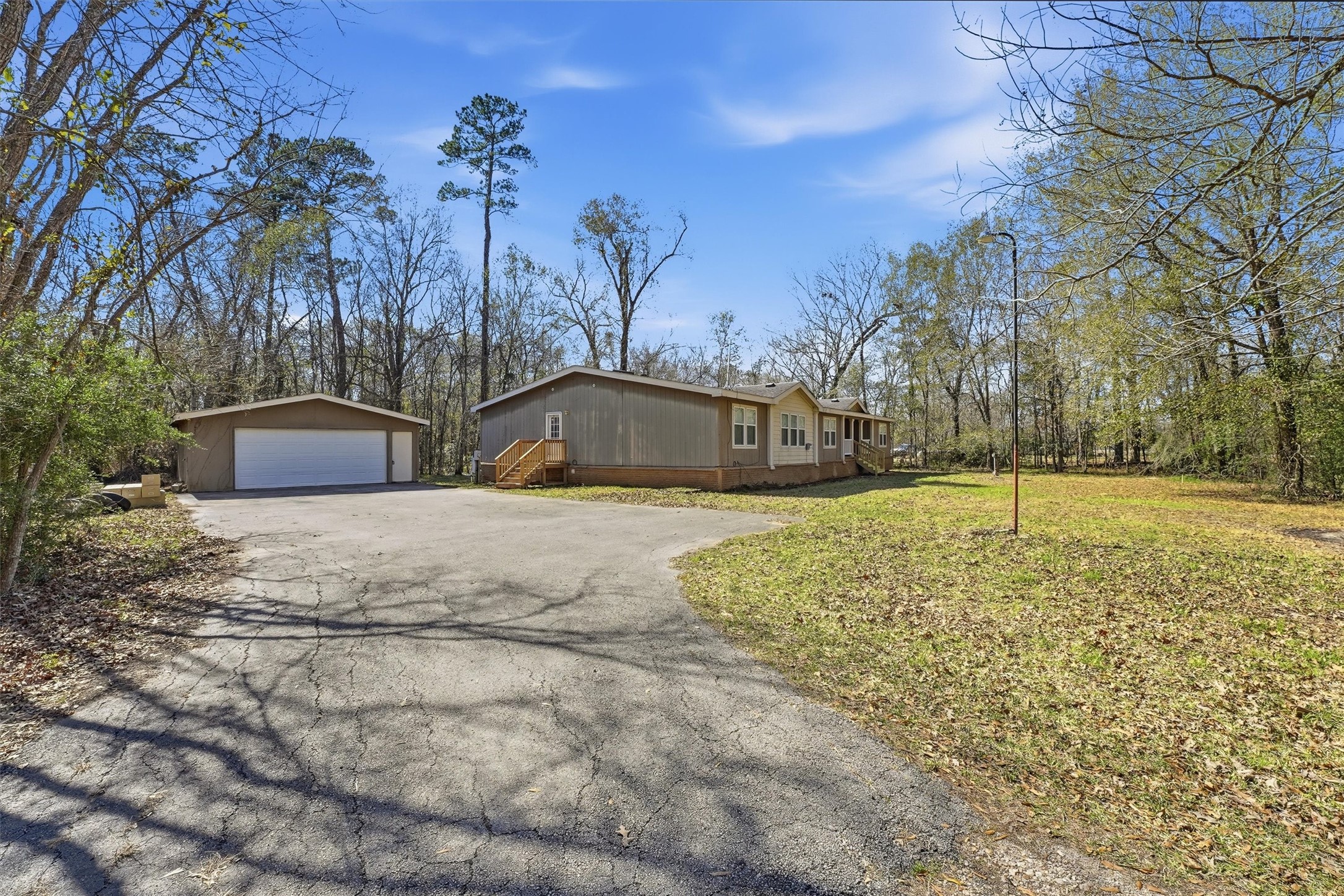351 County Road 6501 Dayton, TX 77535 - Photo 2 of 29 a yellow house with trees in front of it