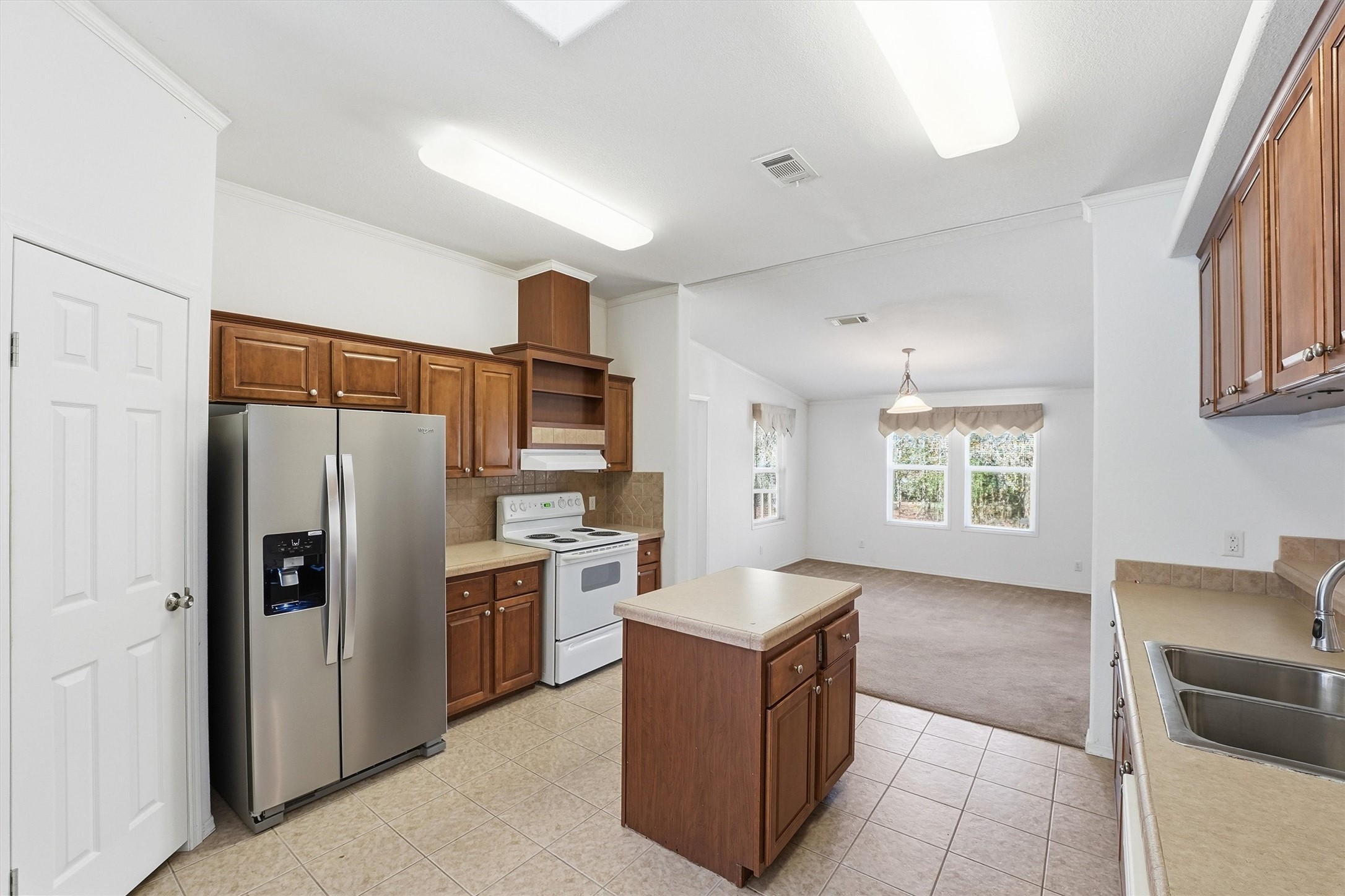 351 County Road 6501 Dayton, TX 77535 - Photo 8 of 29 a kitchen with stainless steel appliances granite countertop a refrigerator stove and sink