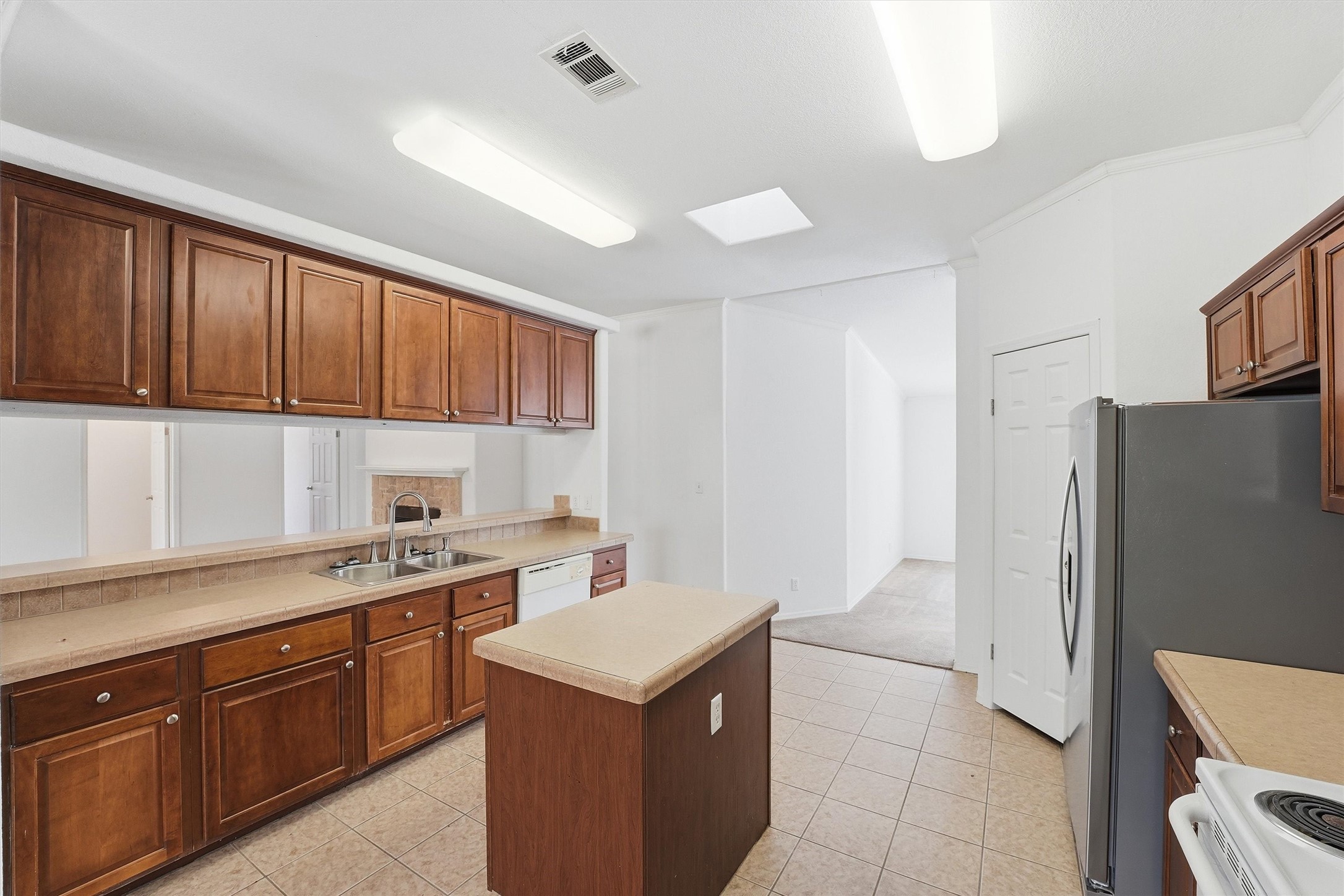 351 County Road 6501 Dayton, TX 77535 - Photo 9 of 29 a kitchen with a cabinets and refrigerator