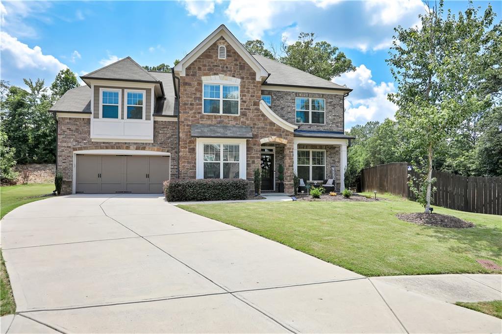a front view of a house with a yard