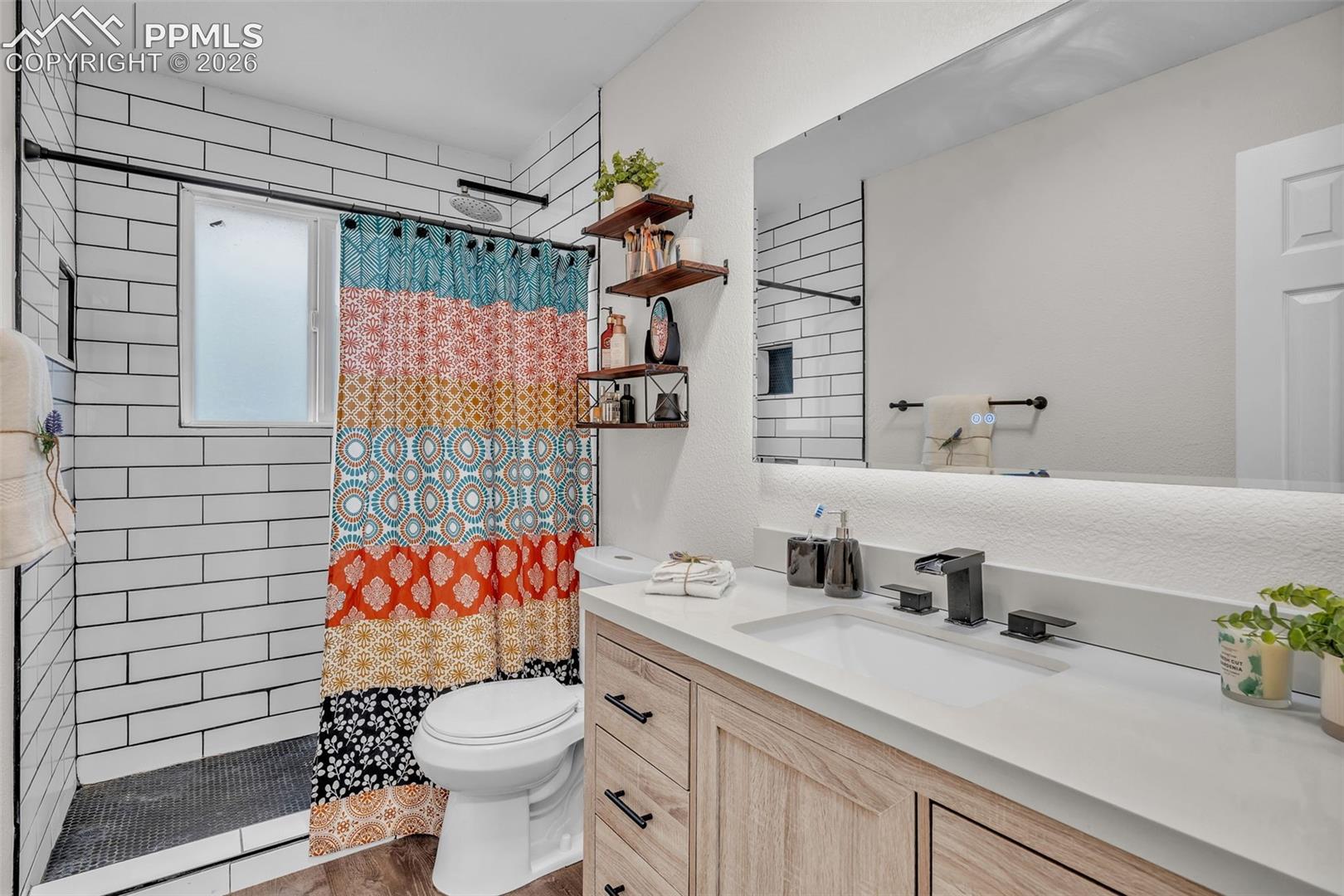 1498 Peterson Road Colorado Springs, CO 80915 - Photo 25 of 44 Full bath featuring vanity and a tile shower