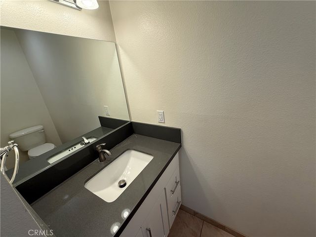 a view of empty room with wooden floor and electronic appliances