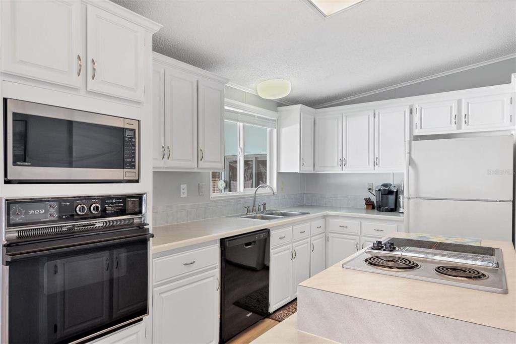 3502 Rita Place Ellenton, FL 34222 - Photo 13 of 46 a kitchen with white cabinets and appliances