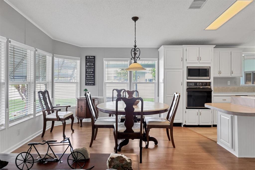 3502 Rita Place Ellenton, FL 34222 - Photo 17 of 46 a view of a dining room with furniture window and wooden floor
