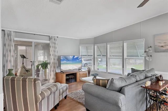 a living room with furniture a large window and a fireplace