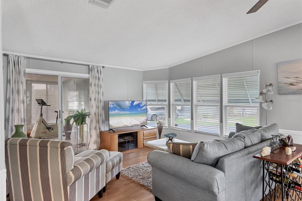 3502 Rita Place Ellenton, FL 34222 - Photo 18 of 46 a living room with furniture a large window and a fireplace