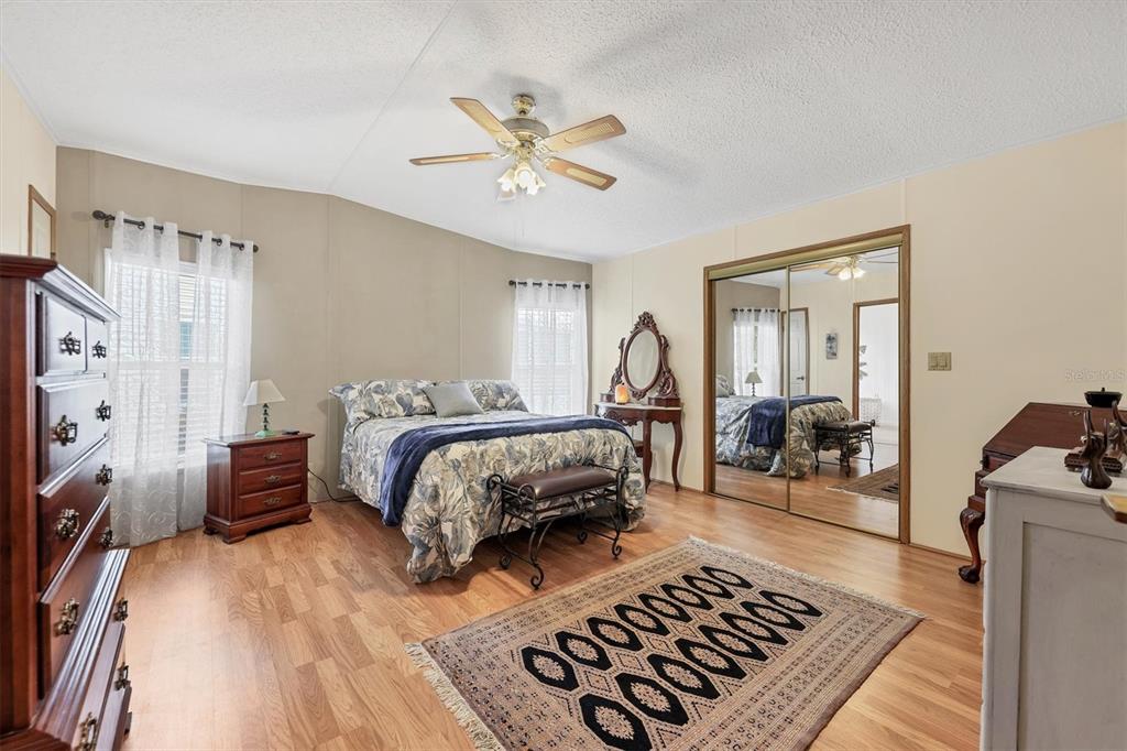 3502 Rita Place Ellenton, FL 34222 - Photo 21 of 46 a bedroom with a large bed and a chandelier