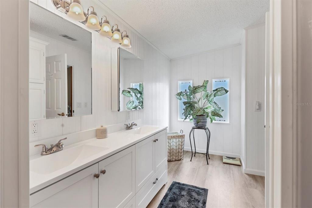 3502 Rita Place Ellenton, FL 34222 - Photo 23 of 46 a spacious bathroom with a double vanity sink and a mirror