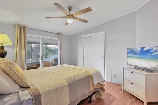 a bedroom with a bed a window and a chandelier
