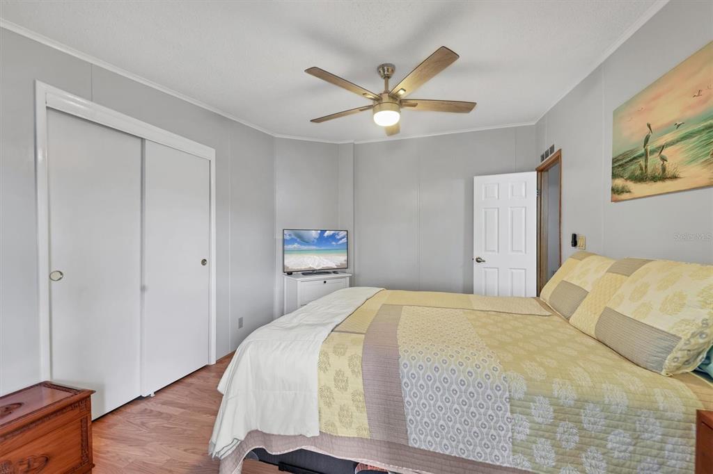 3502 Rita Place Ellenton, FL 34222 - Photo 27 of 46 a bedroom with a bed and a chandelier