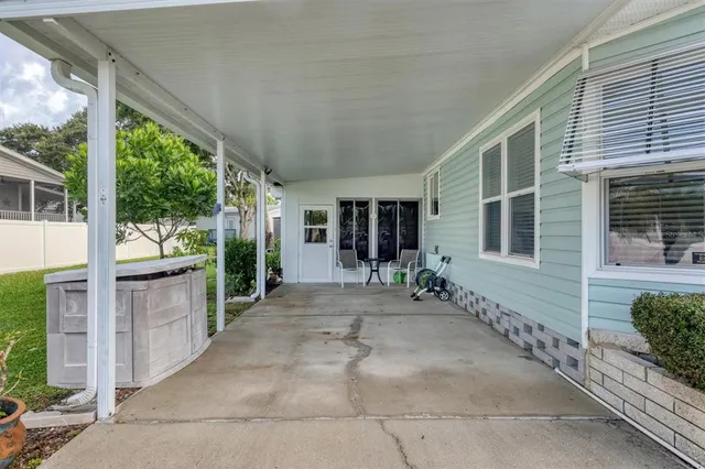 a view of a porch with furniture and garden