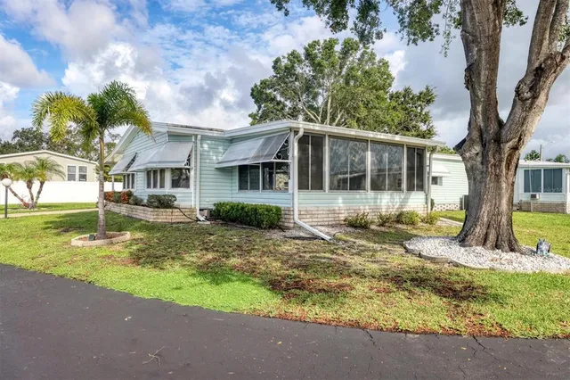 a view of a house with backyard and sitting area