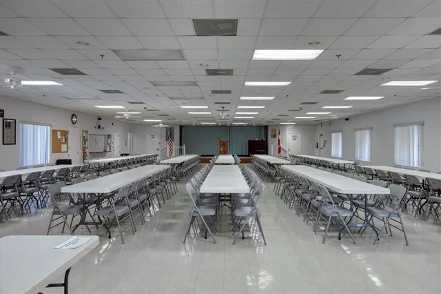 a large room with lots of furniture and a chandelier
