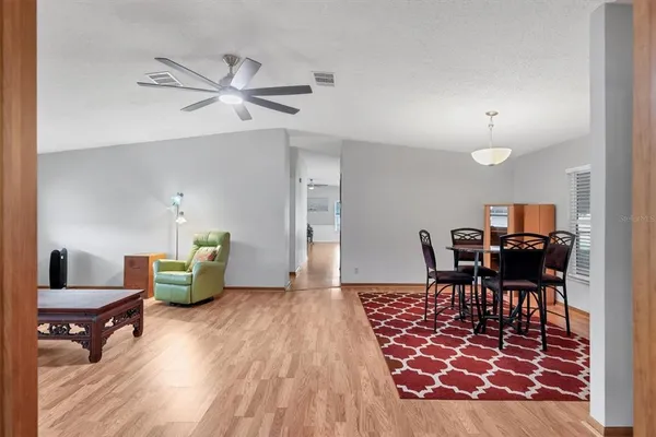 a living room with furniture and a wooden floor