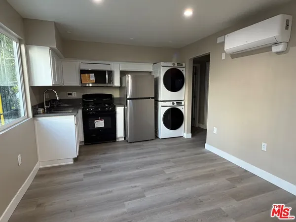 a kitchen with a stove top oven sink and cabinets