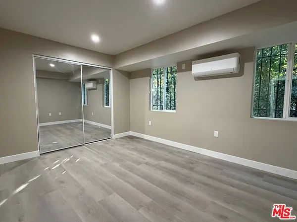 en empty room with windows and closet