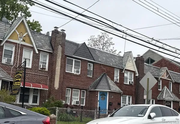 a front view of a residential apartment building with a yard