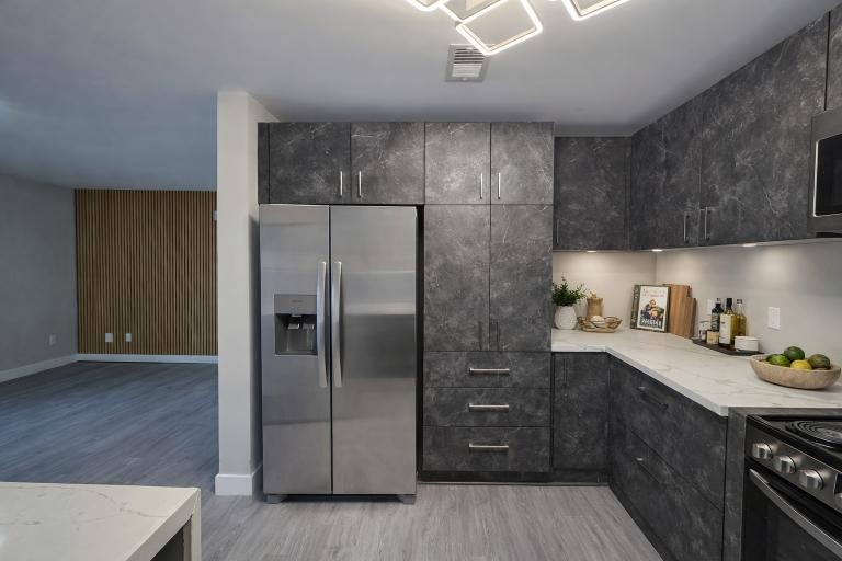 543 Peachers Mill Road Clarksville, TN 37042 - Photo 12 of 29 a kitchen with stainless steel appliances granite countertop a refrigerator a sink and wooden cabinets