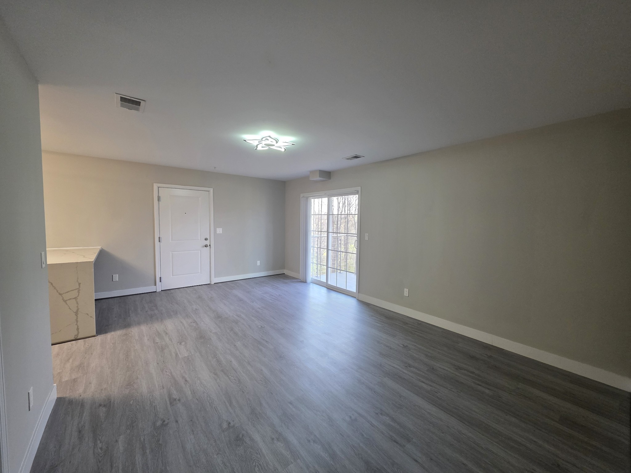 543 Peachers Mill Road Clarksville, TN 37042 - Photo 14 of 29 a view of empty room with wooden floor and fan