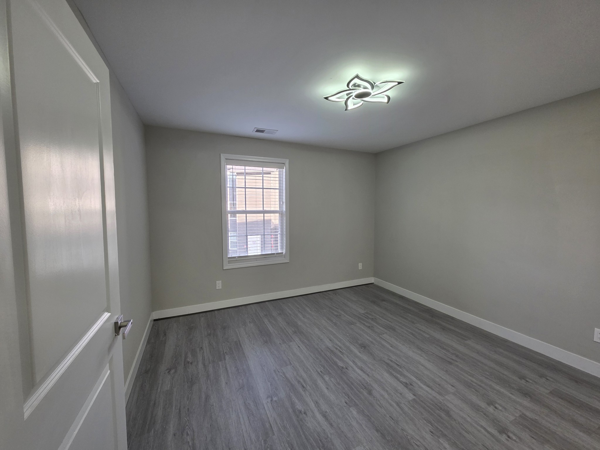543 Peachers Mill Road Clarksville, TN 37042 - Photo 25 of 29 wooden floor in an empty room with a window