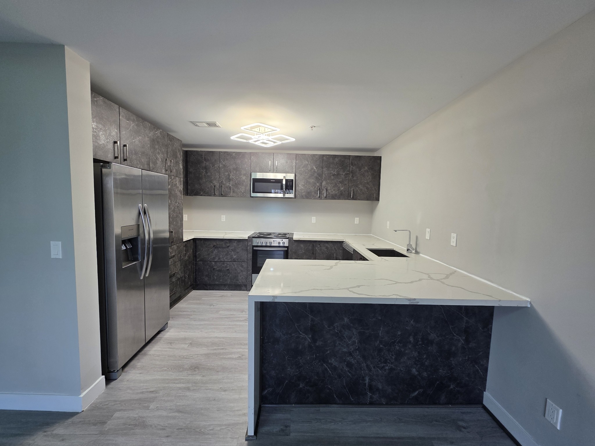 543 Peachers Mill Road Clarksville, TN 37042 - Photo 6 of 29 a large kitchen with a large window and stainless steel appliances