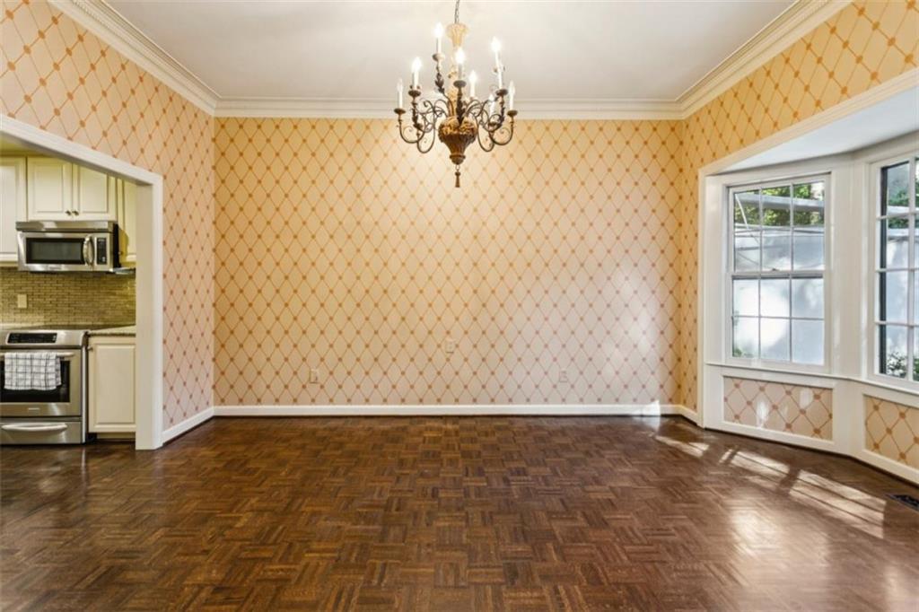 19 Mooregate Square Northwest Atlanta, GA 30327 - Photo 15 of 48 a view of a livingroom with wooden floor and a kitchen space