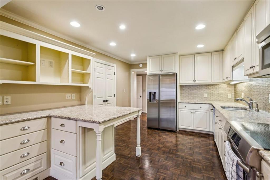 19 Mooregate Square Northwest Atlanta, GA 30327 - Photo 20 of 48 a kitchen with a sink stove and refrigerator