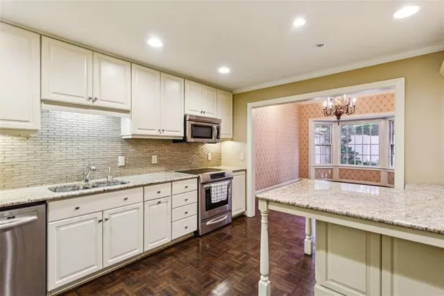 workspace with stainless steel appliances granite countertop furniture and wooden floor