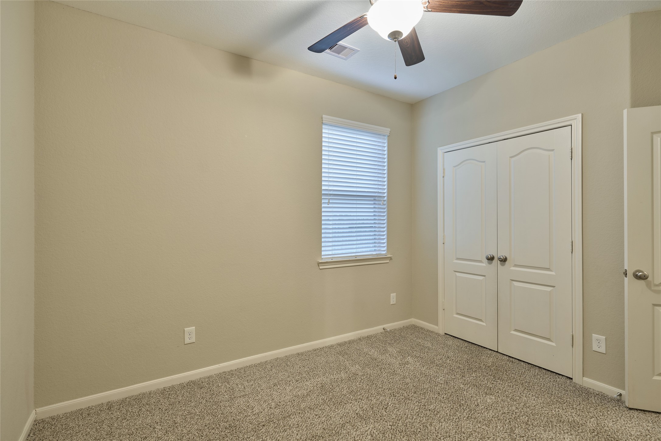 116 Fox Trail Road Montgomery, TX 77316 - Photo 34 of 50 Bedroom 2- offers a ceiling fan for comfort. It features a double-door closets for storage.