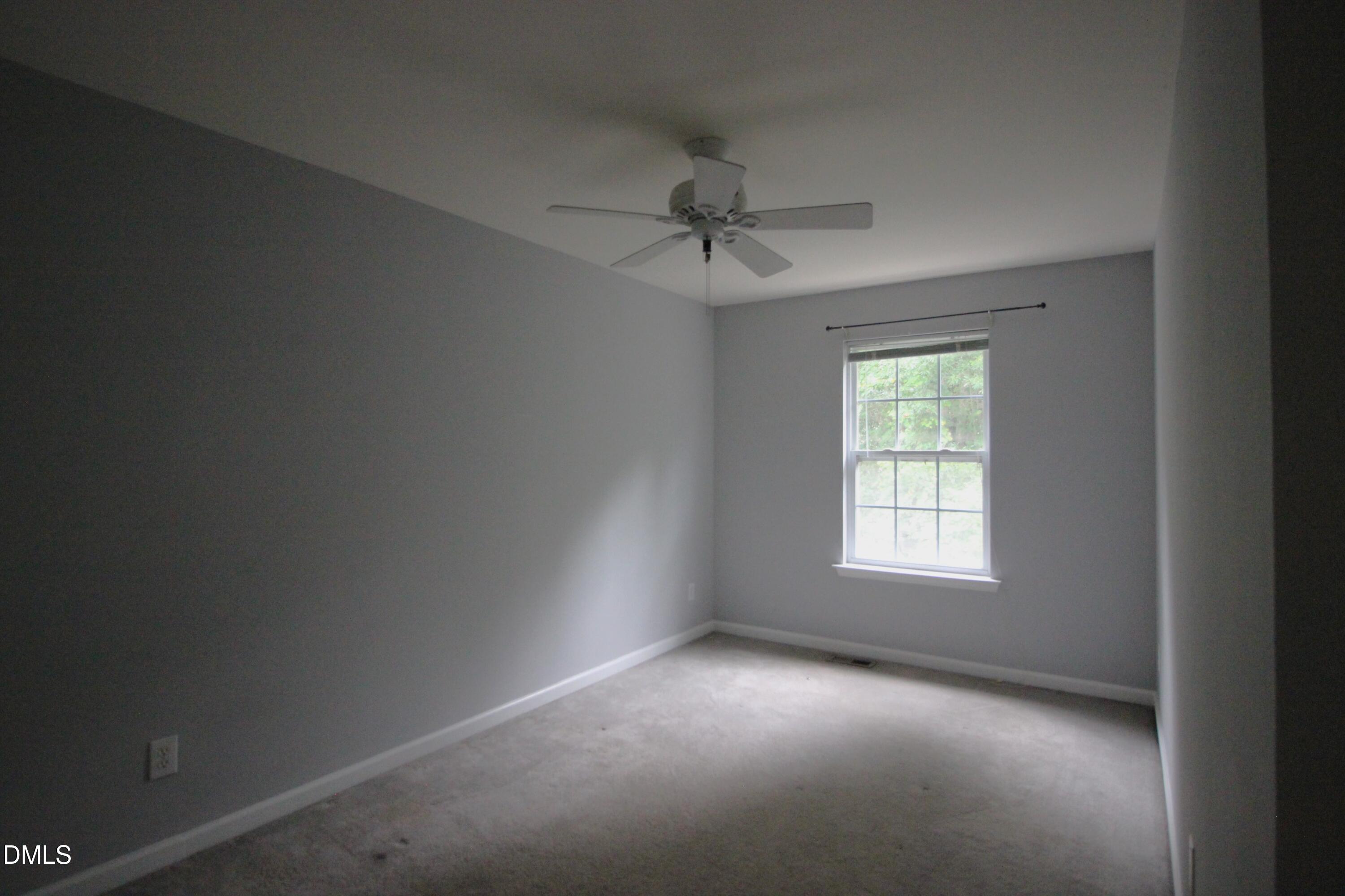 3030 Barrymore Street, Unit 109 Raleigh, NC 27603 - Photo 15 of 17 an empty room with a window and a fan