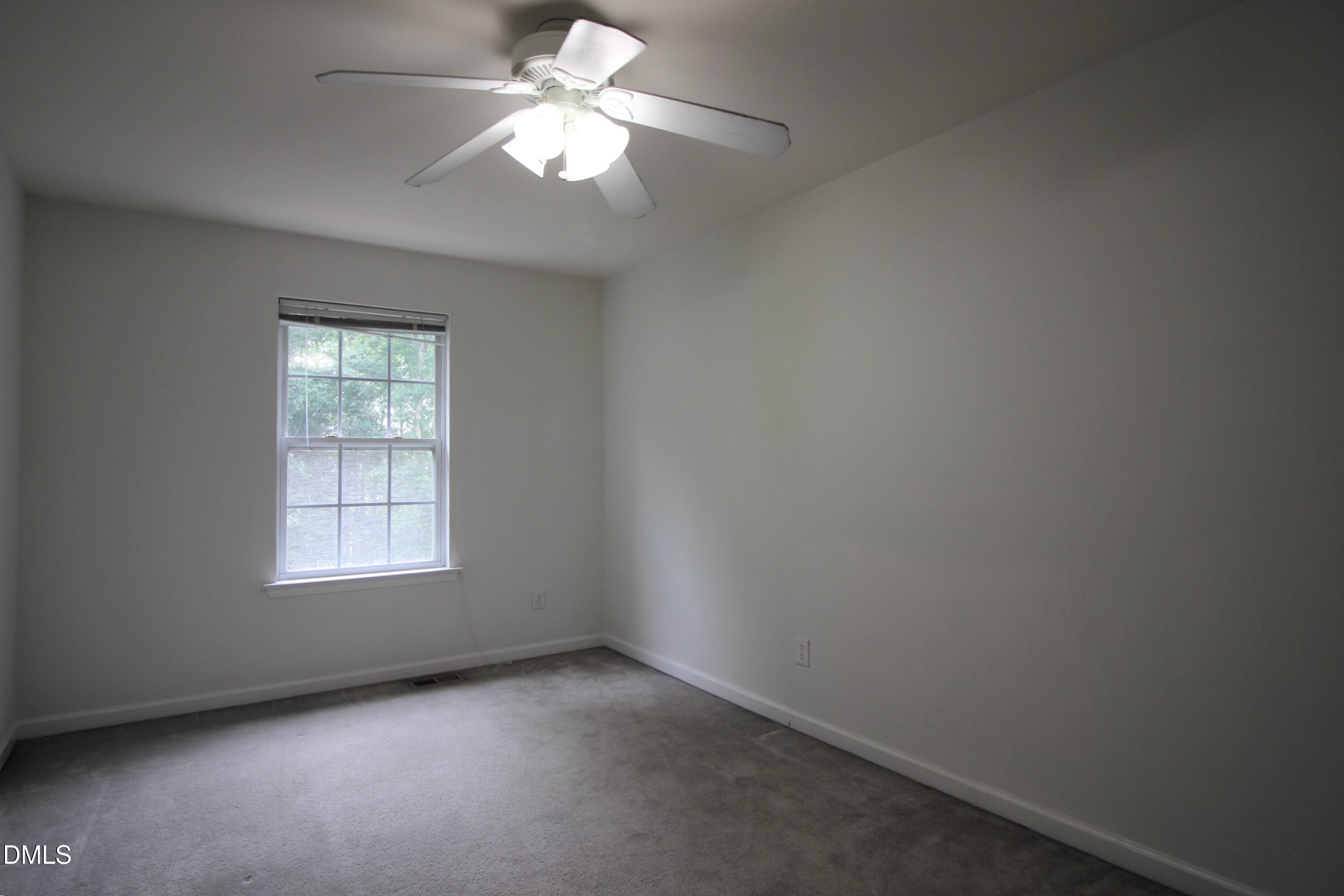 3030 Barrymore Street, Unit 109 Raleigh, NC 27603 - Photo 16 of 17 an empty room with a window and a fan