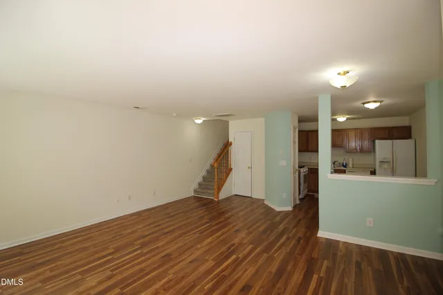 a view of a room with wooden floor and a sink