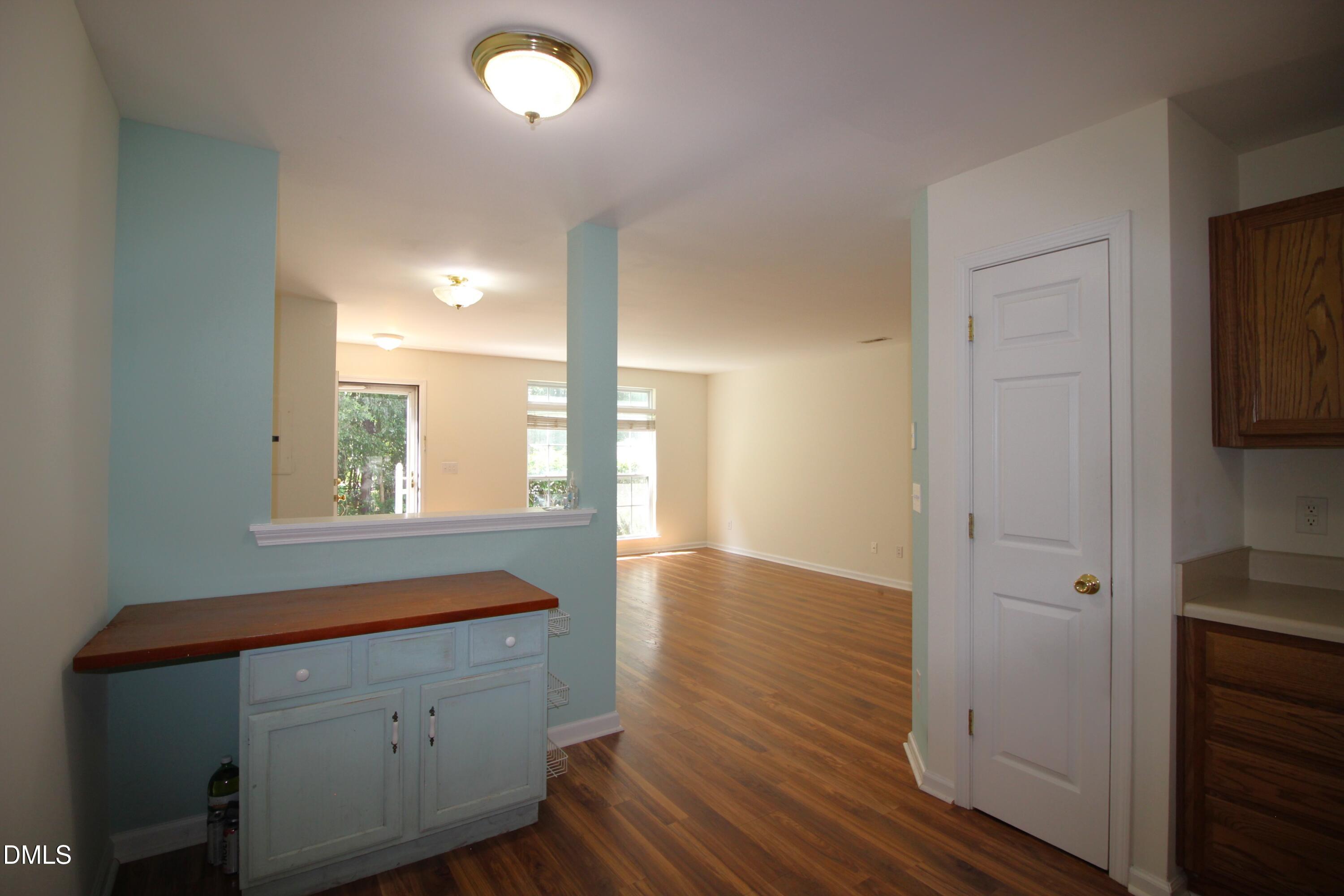 3030 Barrymore Street, Unit 109 Raleigh, NC 27603 - Photo 6 of 17 a room with window and wooden floor