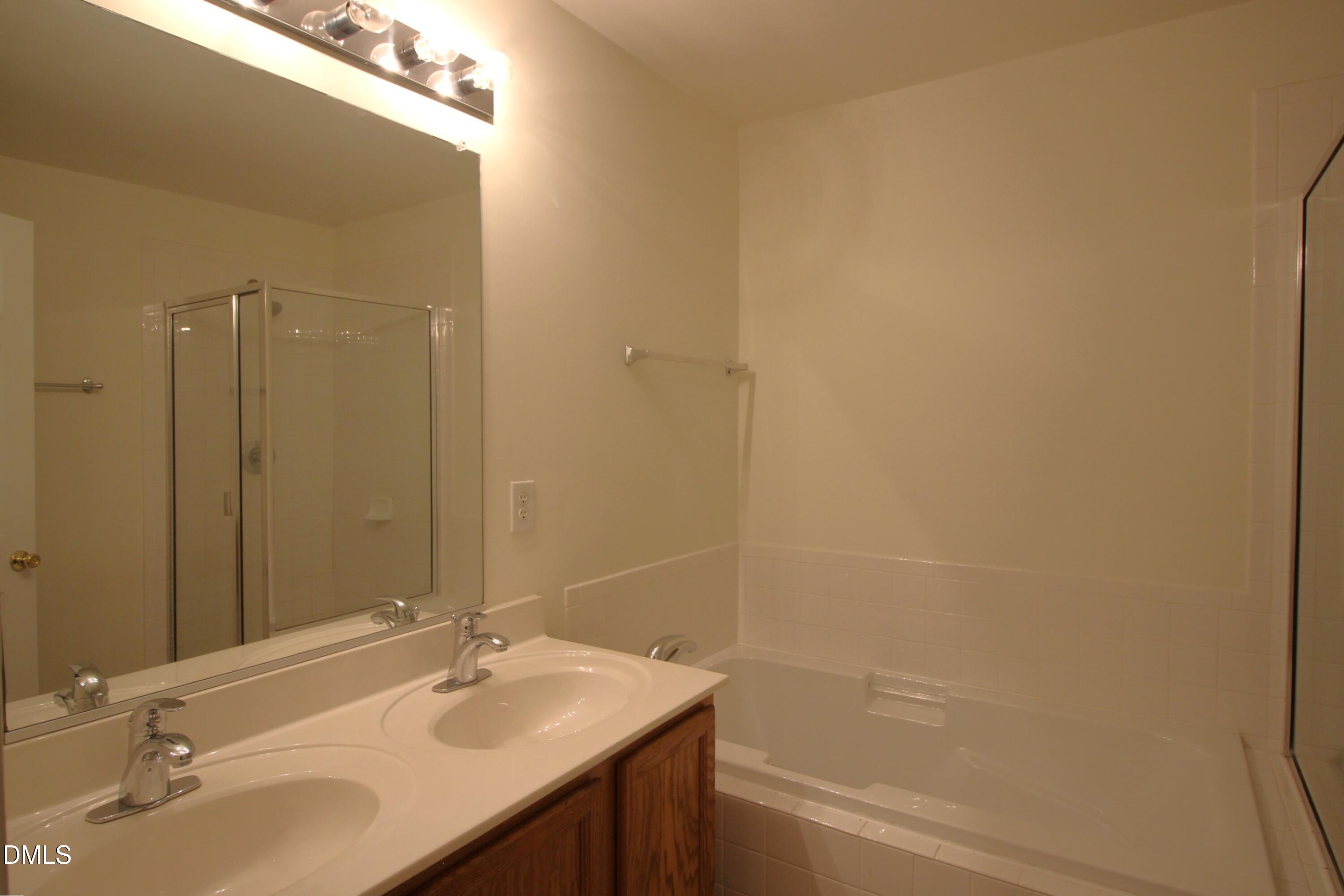 3030 Barrymore Street, Unit 109 Raleigh, NC 27603 - Photo 9 of 17 a bathroom with a sink and a bathtub