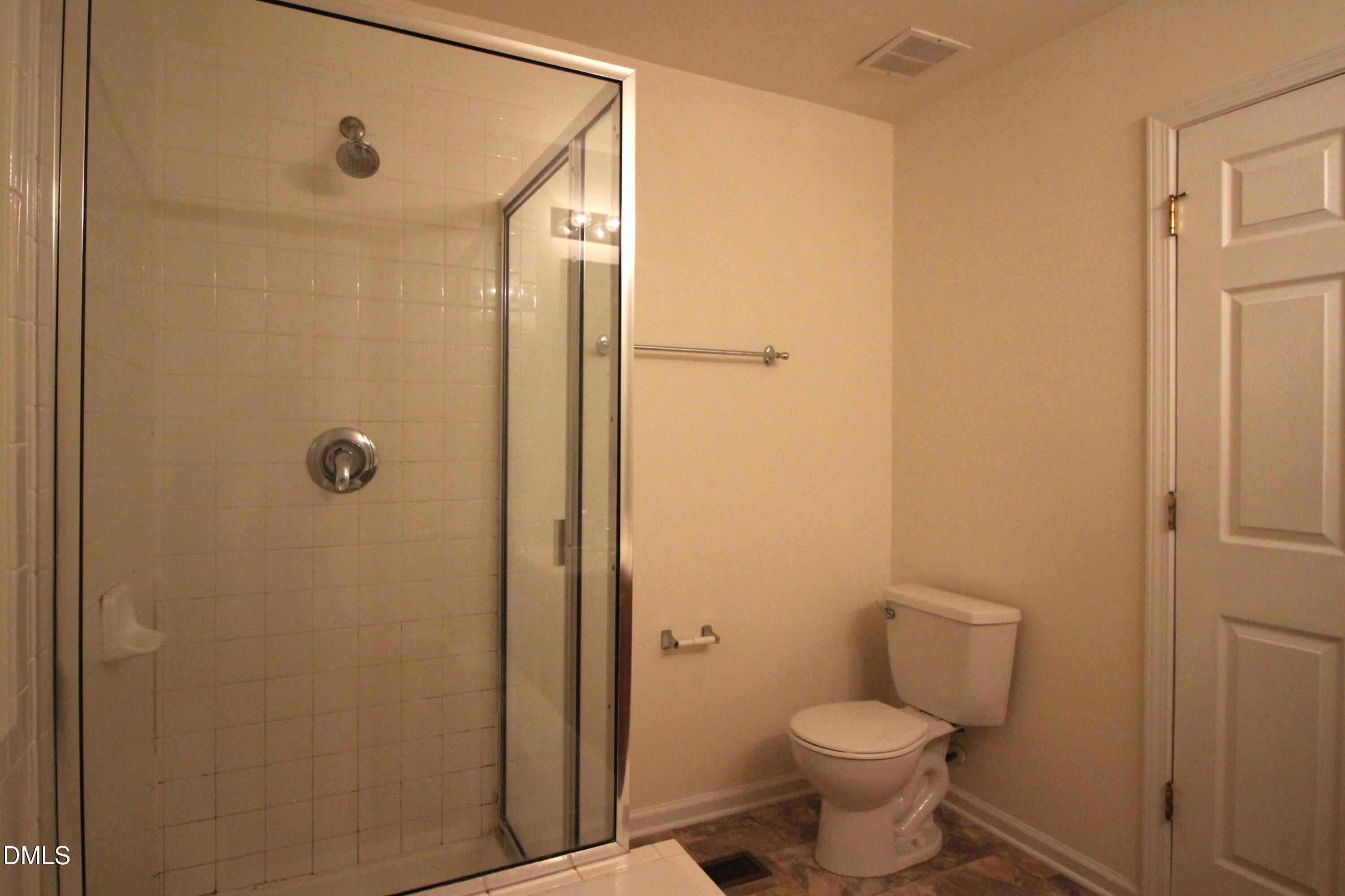 3030 Barrymore Street, Unit 109 Raleigh, NC 27603 - Photo 10 of 17 a bathroom with a toilet and a shower
