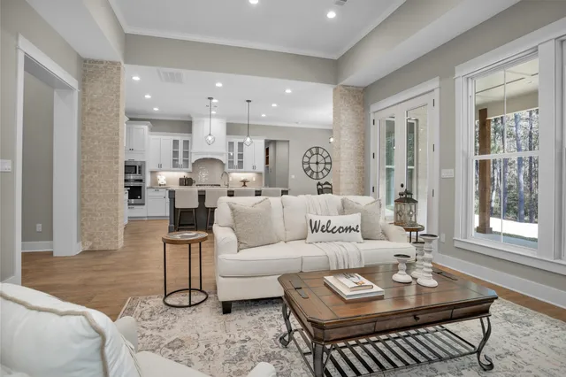 a living room with kitchen island furniture and a wooden floor