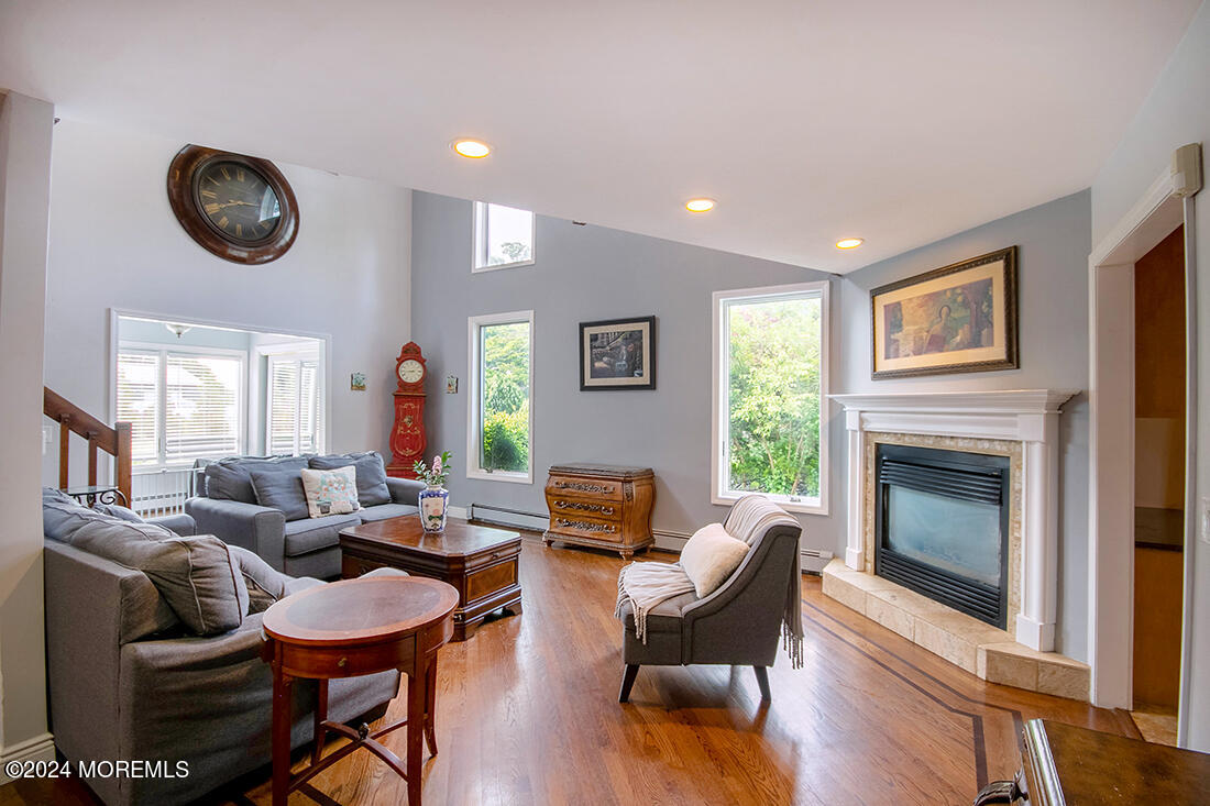 72 Vanderveer Road Freehold, NJ 07728 - Photo 19 of 53 a living room with furniture a fireplace and wooden floor