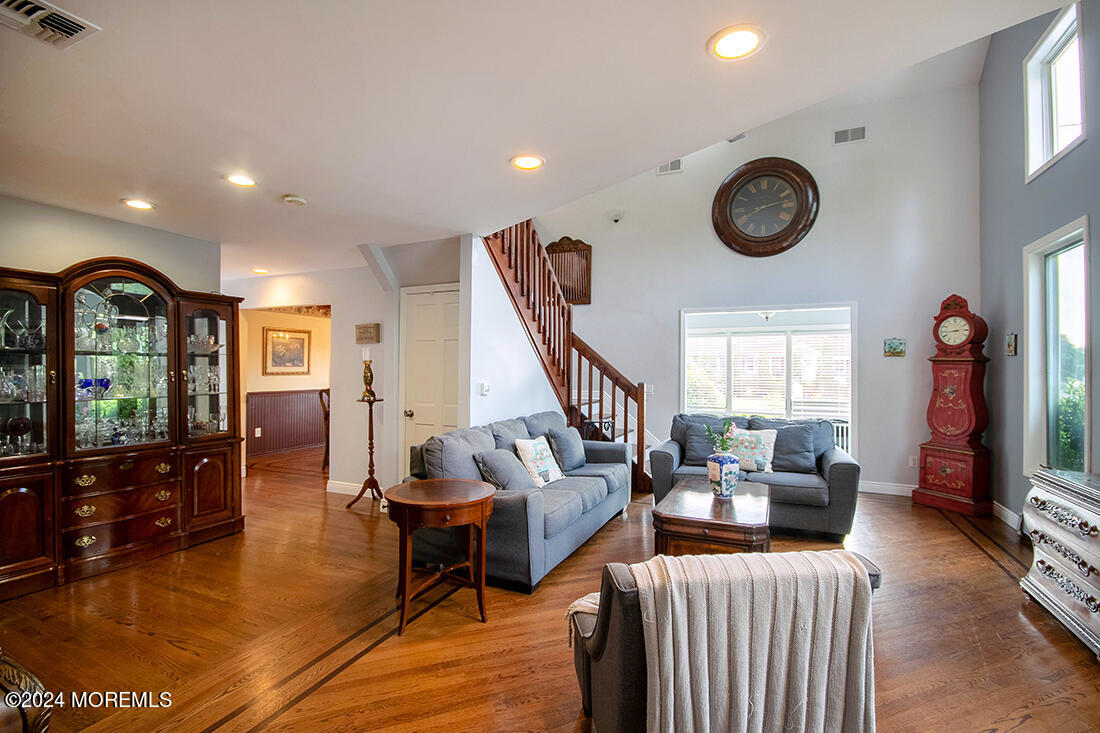 72 Vanderveer Road Freehold, NJ 07728 - Photo 20 of 53 a living room with furniture a window and a clock
