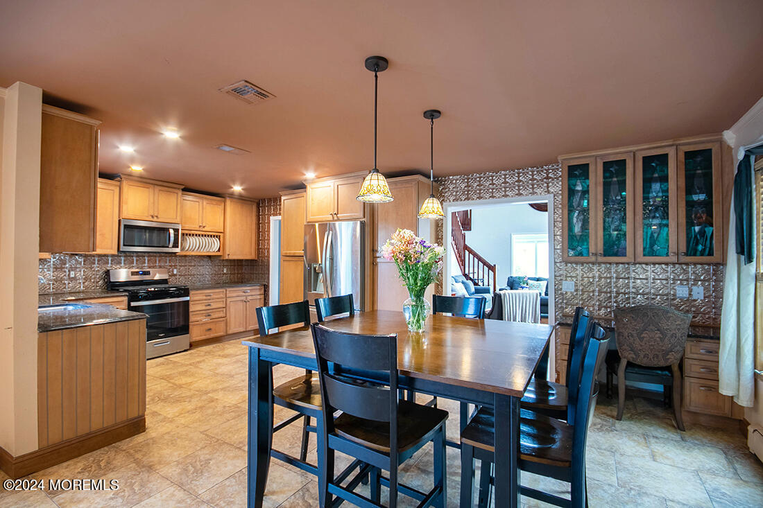 72 Vanderveer Road Freehold, NJ 07728 - Photo 23 of 53 a dining room with furniture a kitchen view and a chandelier