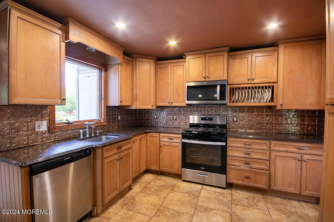 72 Vanderveer Road Freehold, NJ 07728 - Photo 24 of 53 a kitchen with stainless steel appliances granite countertop wooden cabinets a stove top oven a sink and dishwasher