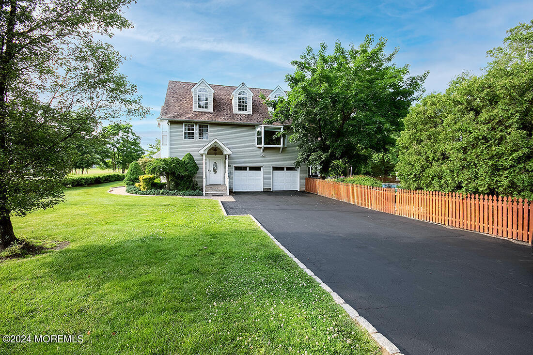 72 Vanderveer Road Freehold, NJ 07728 - Photo 4 of 53 a front view of a house with a yard and garage