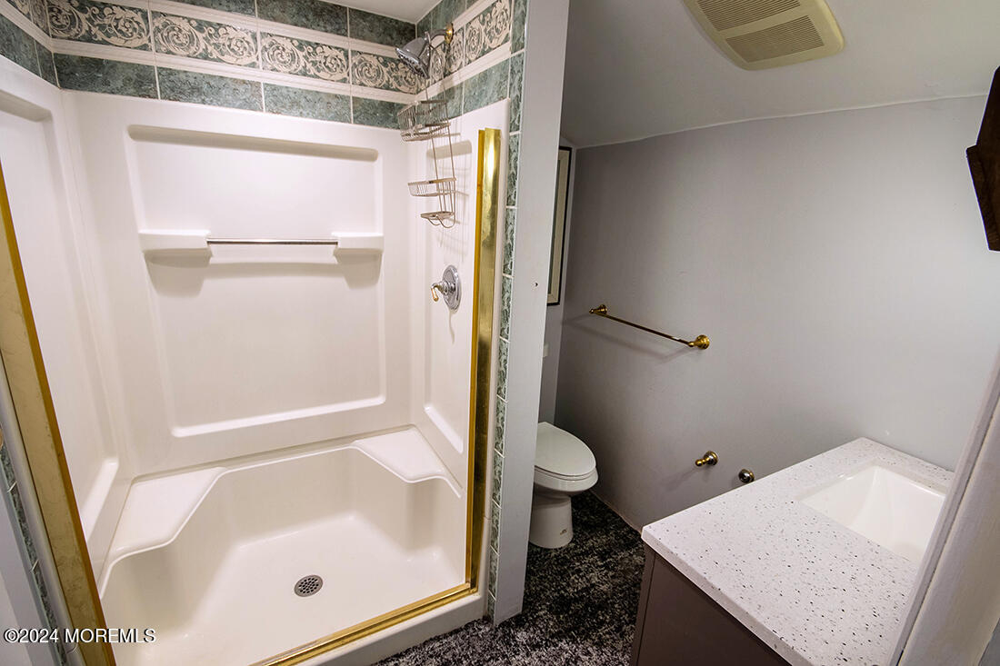 72 Vanderveer Road Freehold, NJ 07728 - Photo 53 of 53 a bathroom with a granite countertop bathtub shower and toilet