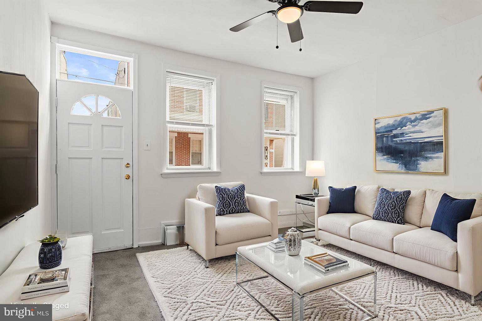 4474 Livingston Street Philadelphia, PA 19137 - Photo 2 of 27 a living room with furniture ceiling fan and a window
