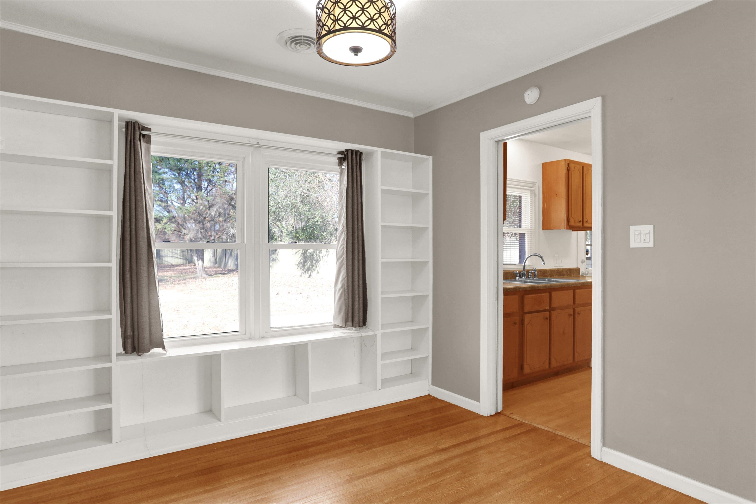 1459 Flamingo Road Memphis, TN 38117 - Photo 20 of 31 a view of an empty room with a window and wooden floor